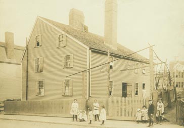 Exterior view of Gedney House with children standing on street, Salem, Mass.