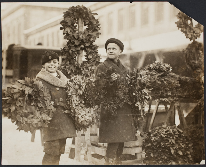 Children holding Christmas wreaths